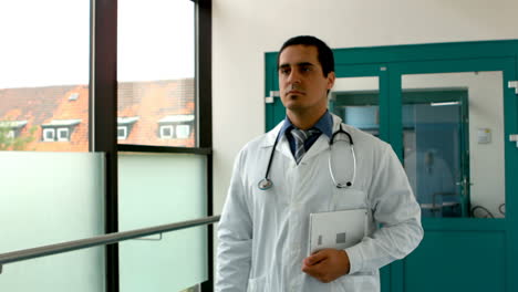 Male-doctor-holding-digital-tablet