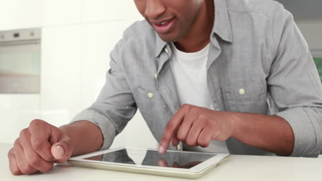 Smiling-man-using-his-tablet