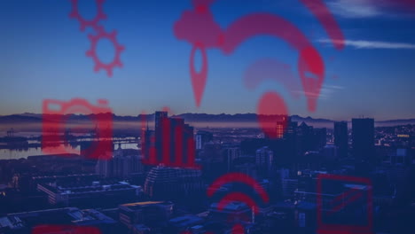 Animation-of-multiple-digital-icons-floating-against-aerial-view-of-cityscape