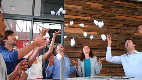 Business-executives-throwing-crumpled-paper-in-air