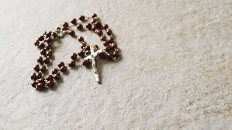 Close-up-of-rosary-on-white-background-with-copy-space