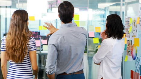 Group-of-executives-discussing-over-sticky-notes