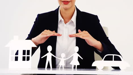 Businesswoman-with-paper-cut-out-of-a-family