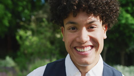 Portrait-of-happy-biracial-man-on-sunny-day-at-wedding