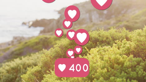 Animation-of-social-media-heart-icons-and-shore-with-sea-landscape