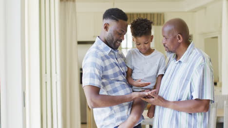 Happy-african-american-son,-father-and-grandfather-comparing-hands,-slow-motion,-copy-space