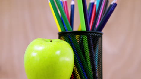 Pen-holder-with-color-pencil-and-apple