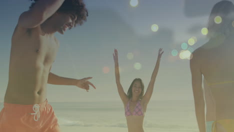 Animation-of-light-spots-over-happy-diverse-friends-dancing-at-beach