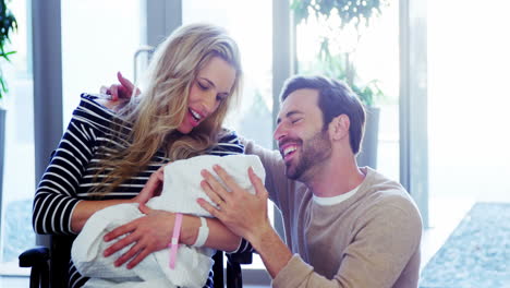 Couple-looking-at-their-newborn-baby