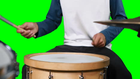 Mid-section-of-drumer-playing-drum