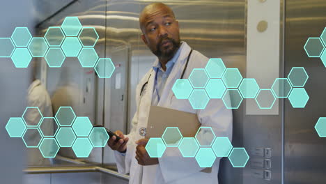 Animation-of-cell-structures-processing-data-over-african-american-male-doctor-using-smartphone