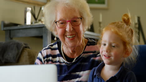 Großmutter-Und-Enkelin-Nutzen-Digitales-Tablet-Im-Wohnzimmer-4K