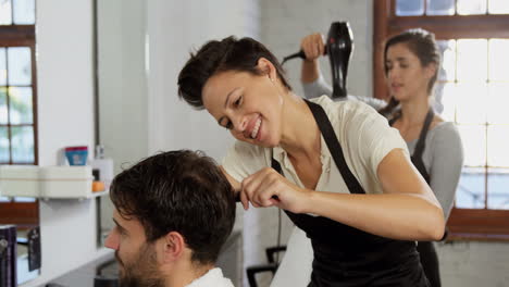 Hairdresser-trimming-her-client-hair