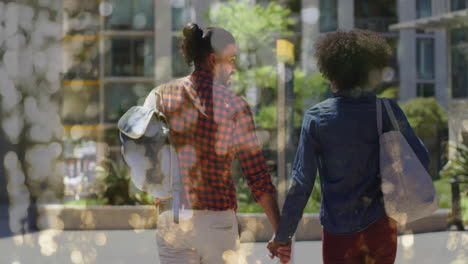 Animation-of-bokeh-over-diverse-couple-walking-and-holding-hands,-slow-motion