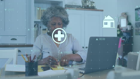 Animation-of-data-processing-over-senior-african-american-woman-using-laptop