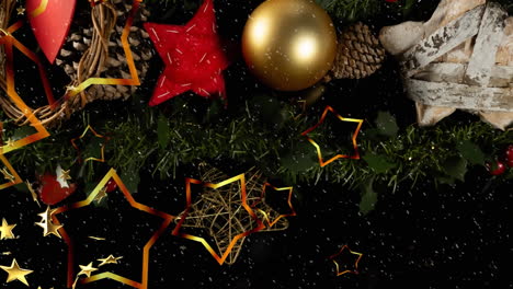 Animation-of-stars-falling-over-christmas-tree-with-baubles