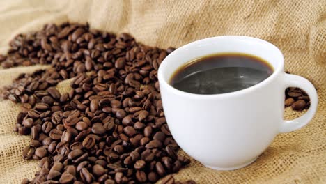 Café-Negro-Servido-En-Saco-Con-Granos-De-Café.
