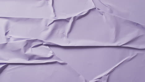 Video-of-close-up-of-violet-creased-fabric-with-copy-space