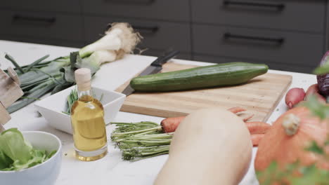 Close-up-of-fresh-vegetables-on-countertop-in-kitchen,-slow-motion