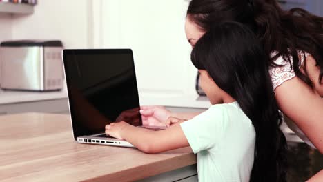 Mother-and-her-daughter-using-laptop-