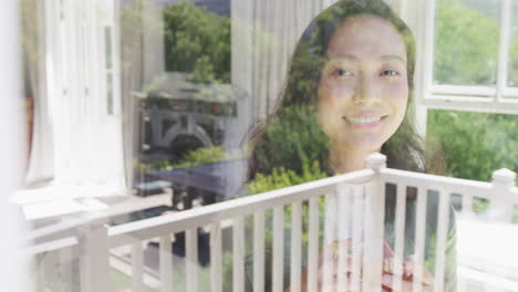 Portrait-of-happy-asian-woman-looking-through-window,-in-slow-motion
