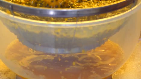 Stirring-passion-fruit-pulp-to-separate-the-juice-through-a-sieve-into-a-bowl