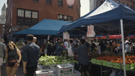 Slow-motion-shot-of-a-busy-farmers-market-in-downtown-Boston-during-the-day