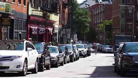 Slow-motion-shot-of-a-street-lined-with-parked-cars-in-downtown-Boston