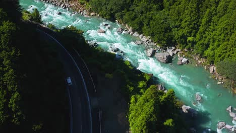 Cars-Drive-through-River-Gorge-in-Kochi,-Japan,-4k-Aerial-View