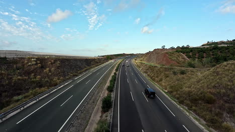 A-Still-Shot-Of-Tarred-Road-With-Cars-Travelling-At-A-Clear-Rustic-Landscape-In-Spain