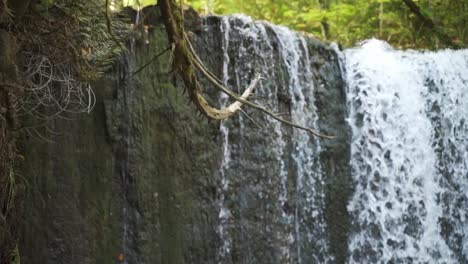 Close-up-of-water-flowing-over-a-cliff-edge-in-a-forest-in-Milton,-Ontario