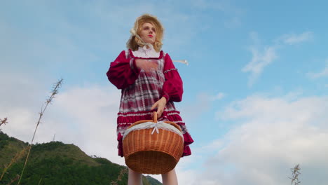 blonde-female-model-in-traditional-old-fashioned-renaissance-medieval-clothing-dress-low-angle-holding-food-basket