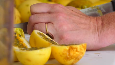 Home-cook-cutting-passion-fruit-on-a-chopping-board