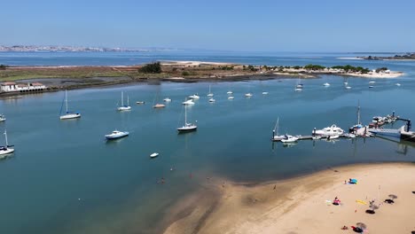 Drone-shot-tilting-up-and-descending-by-the-anchored-yachts-near-Seixal-in-Portugal