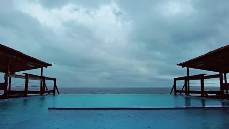 Time-lapse-of-rain-hitting-a-swimming-pool-in-a-holiday-resort