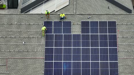 Workers-with-harnesses-carrying-solar-panels