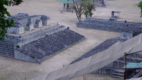Pan-over-hieroglyphic-stairway-and-ball-court-in-Acropolis,-Copan-ruins