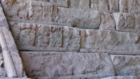 Pan-across-ornate-carved-pyramid-stones-at-Copan-Mayan-ruin,-Honduras