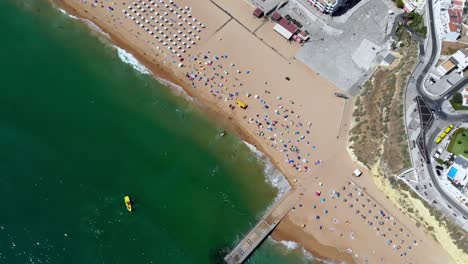 Drone-shot-rising-and-twisting-over-the-beach-in-Albufeira