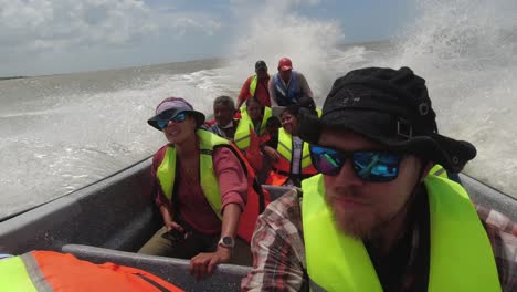 Dynamic-POV:-Tourists-enjoy-rough-boat-ride-on-choppy-grey-ocean