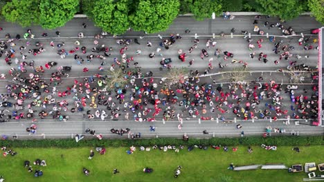 Start-line-of-marathon-with-people-gathering-on-street-during-running-event,-top-down
