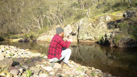 A-bushman-smokes-a-pipe-by-a-river-in-the-Victorian-High-Country