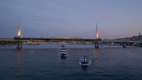 Evening-ferry-boats-sail-illuminated-Golden-Horn-metro-bridge-Istanbul