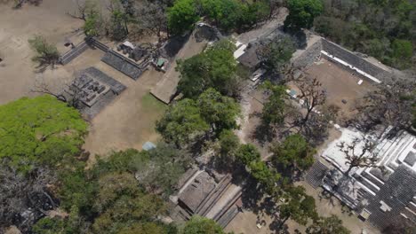 Aerial-rotates-over-temple,-ball-court-and-plaza-at-Copan-Mayan-ruins