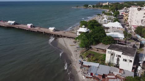 Aerial-view-of-waterfront-beach-and-tourist-dock-at-La-Ceiba,-Honduras