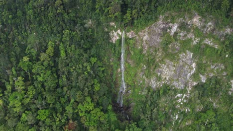 Aerial-retreat-from-beautiful-tall-jungle-waterfall,-Cascada-el-Bejuco