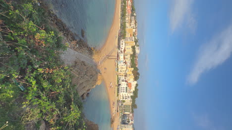 Vertical-video-of-spectacular,-beach-on-the-Costa-Brava,-blue-sky-with-copy-space,-blue,-turquoise-water,-European-tourism