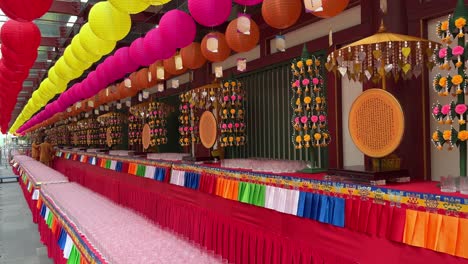 Monks-preparing-blessing-lamps-for-an-event-10000-Lamp-Offerings-to-Buddhas-of-the-Ten-Directions-during-the-Mid-Autumn-period-at-Buddha-Tooth-Relic-Temple,-Chinatown,-Singapore