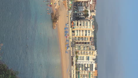 Vertical-format-video,-Blanes-Mediterranean-beach-on-the-Costa-Brava,-blue-sky-copy-space