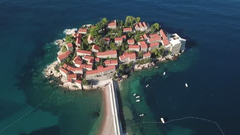 drone-fly-above-scenic-travel-destination-Sveti-Stefan-island-town-in-Budva-Municipality,-on-the-Adriatic-coast-of-Montenegro